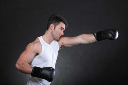 Portrait sportsman boxer in studio against dark backgroundの写真素材