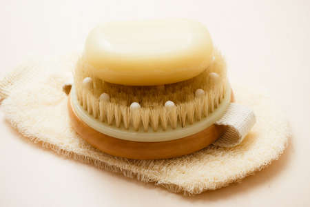 Beauty and skin care. Spa products bath accessories scrub brush soap and massage glove on wooden table.の写真素材