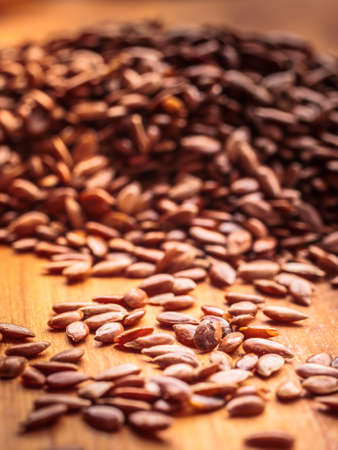 Healthy food for preventing heart diseases and overweight. Flax seeds linseed heap closeup on wood backgroundの写真素材