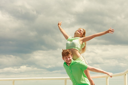 Summer happiness concept. Woman and man young couple in love playing sharing free time having fun...
