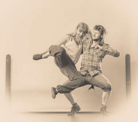 Two modern dancers couple woman and man dancing in the garage. Urban lifestyle. Hip-hop generation.の写真素材