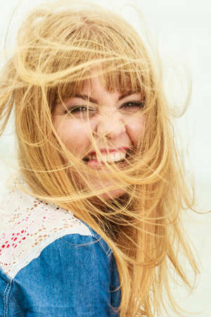 Summer freedom happiness concept. Girl long blonde hair enjoying summer breeze by seasideの写真素材