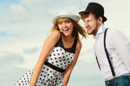 Summer holidays love relationship and dating concept - romantic playful couple retro style flirting outdoor sky backgroundの写真素材