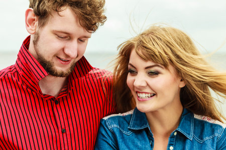 Loving young couple spending leisure time together outdoor, portrait of woman and man
