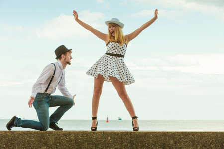 Summer holidays love relationship and dating concept - romantic playful couple retro style flirting on sea shoreの写真素材