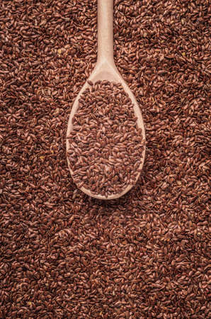 Healthy food diet. Closeup brown flax seeds linseed on wooden spoonの写真素材
