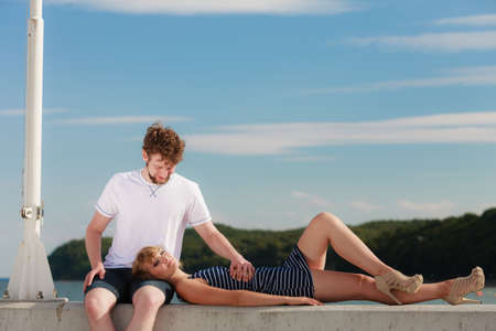 Romantic heterosexual couple in love relaxing peaceful outdoor enjoying sunlight good timeの写真素材