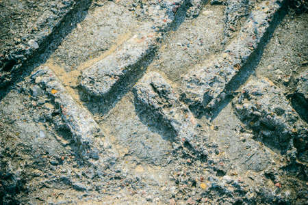 Gray grunge wall stone background or texture solid rock with tractor trackの写真素材