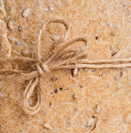 Loaf of whole wheat bread with sunflowers seeds as food background with rustic stringの写真素材