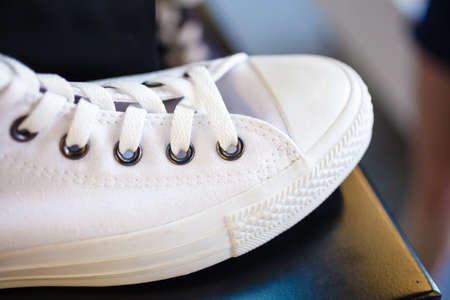 Sport fashion. Closeup white fashionable sneakers on shop shelfの写真素材