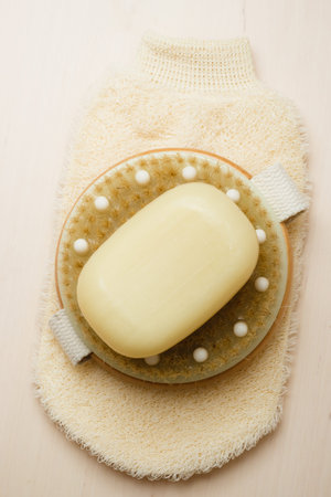 Beauty and skin care. Spa products bath accessories scrub brush soap and massage glove on wooden...