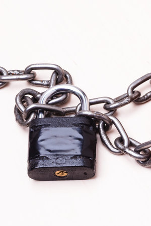 Security concept. Black padlock and iron chain.