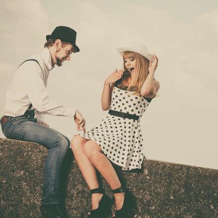 Summer holidays love relationship and dating concept - romantic playful couple retro style flirting on sea shoreの写真素材