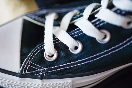 Sport fashion. Closeup navy blue fashionable sneakers on shop shelfの写真素材