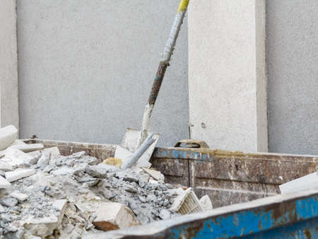 Full construction waste debris container, garbage bricks and material from demolished houseの写真素材