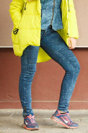 Young fashionable girl wearing jacket. Preparing herself clothes. Fashion in winter time.の写真素材