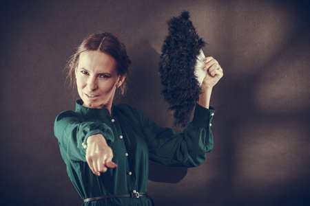 Vintage woman retro style with black feather fan on darkの写真素材
