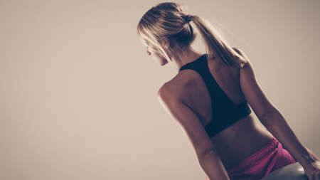 Sport, training, gym and lifestyle concept. Woman in sporstwear black bra doing fitness exercisesの写真素材
