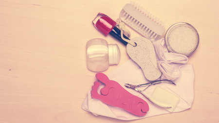Foot care. Pedicure accessories set tools on wooden board background top view with copy spaceの写真素材