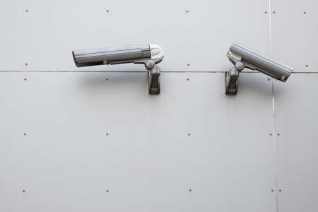 Security camera on the gray wall outdoor.の写真素材