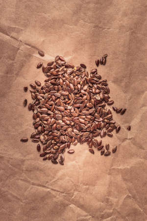 Healthy food organic nutrition. Flax seeds linseed heap on paper backgroundの写真素材