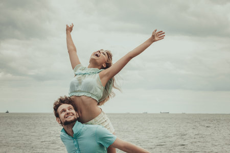 Summer happiness concept. Woman and man young couple in love playing sharing free time having fun...