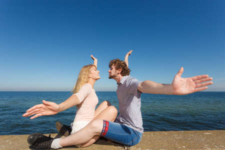 Happiness dating concept. Couple in love blonde woman handsome bearded man enjoy romantic date kissing, outdoor wide angle viewの写真素材
