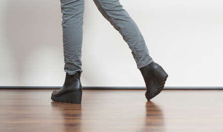 Young fashionable girl with long legs wearing black shoes on platform. Fashion in winter time.の写真素材