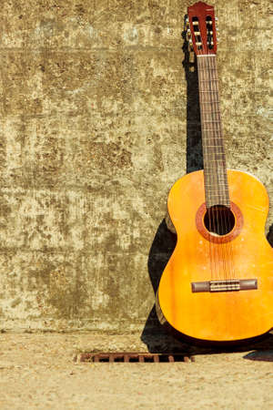acoustic guitar outdoor on wall grunge background with copy spaceの写真素材