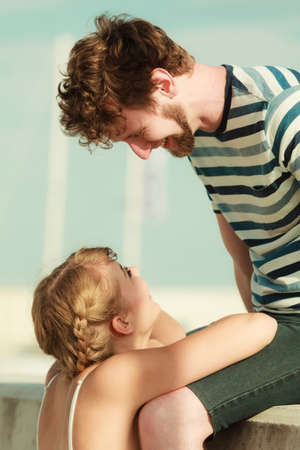 Romantic heterosexual couple in love relaxing peaceful outdoor in marina enjoying good timeの写真素材