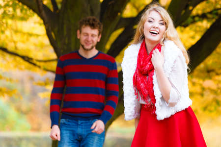 Affection and feelings. Expressing positive emotions. Friendship and love. Young couple meet at autumnal park having fun on a romantic date.の写真素材