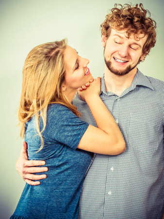 Happy romantic young couple. Smiling friends woman and man in studio.