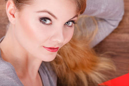 Attractive girl lying on floor.の写真素材