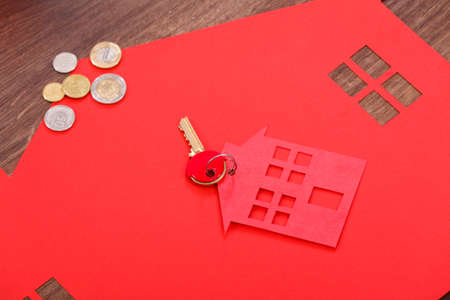 Home cutout with keys and coins.の写真素材