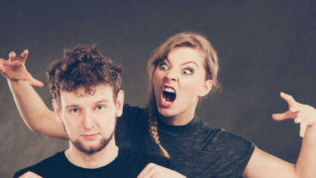 Young couple arguing. Blonde woman in fury yelling on man.の写真素材