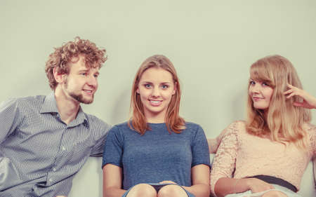 Three young people relaxing at home.の写真素材