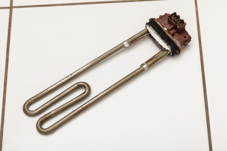 Industry technology housework laundry concept. New heater for washing machine. New internal part ready to be installed.の写真素材