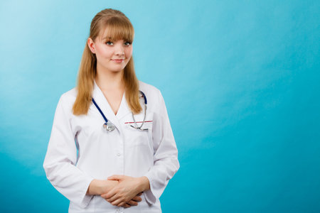 Medicine and healthcare. Portrait of young smiling female doctor. Woman professionalist in white medical uniform.の写真素材