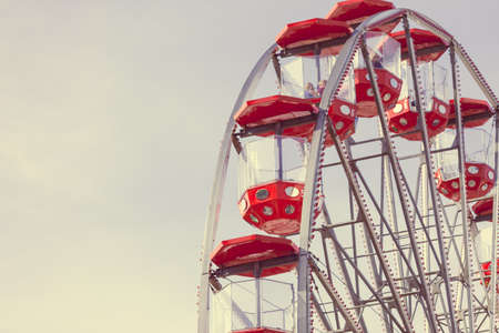 Ferris wheel on blue sky, carousel in amusement parkの写真素材