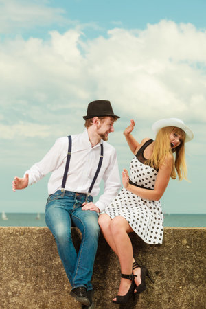 Summer holidays love relationship and dating concept - romantic playful couple retro style flirting on sea shoreの写真素材