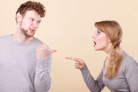 Problems in relationship. Young blonde couple arguing and yelling on each other. Emotional way to express bad feelings.の写真素材