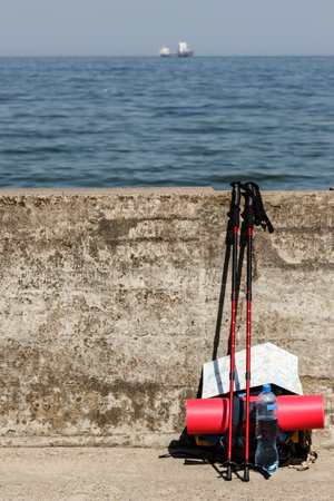 Equipment survival leisure trip holidays concept. Outdoor gear left outside. Bagpack map nordic...