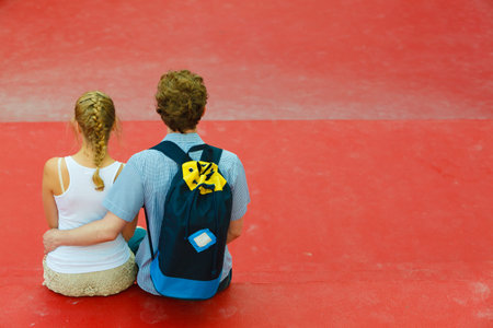 Love romance outdoor trip relax leisure concept. Couple on trip hugging. Young boy and girl sitting together.の写真素材