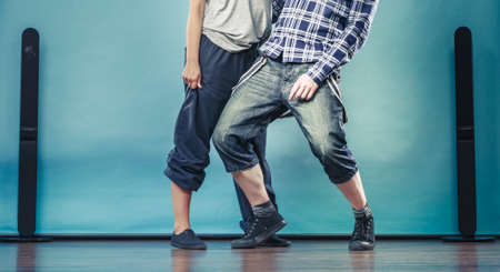 Two modern dancers couple teen woman and man dancing on blue. Urban lifestyle. Hip-hop generation.の写真素材