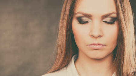 Elegance and beauty of women. Close up of female face with beautiful elegant dark eyes make up. Young woman with stunning amazing facial look.の写真素材