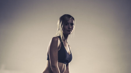 Sport, training, gym and lifestyle concept. Woman in sporstwear black bra doing fitness exercises