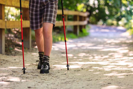 Outdoor survival sport leisure relax concept. Person travelling on dirt road. Young hiker during trip.の写真素材