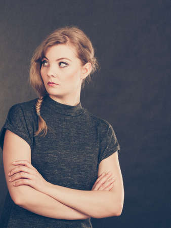 Facial emotions expression. Young blonde expressive angry furious resentful woman. Emotional girl full of anger and bad feelings.の写真素材