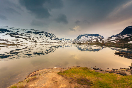 Norway hiking area, scenic mountains landscape, hills and frozen lake