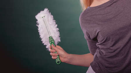 Cleaning time. Female hand holding rag cloth to clean house. Professional service with equipment.の写真素材